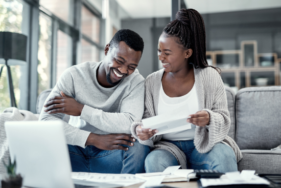 A couple reviewing documents for purchasing a vehicle.